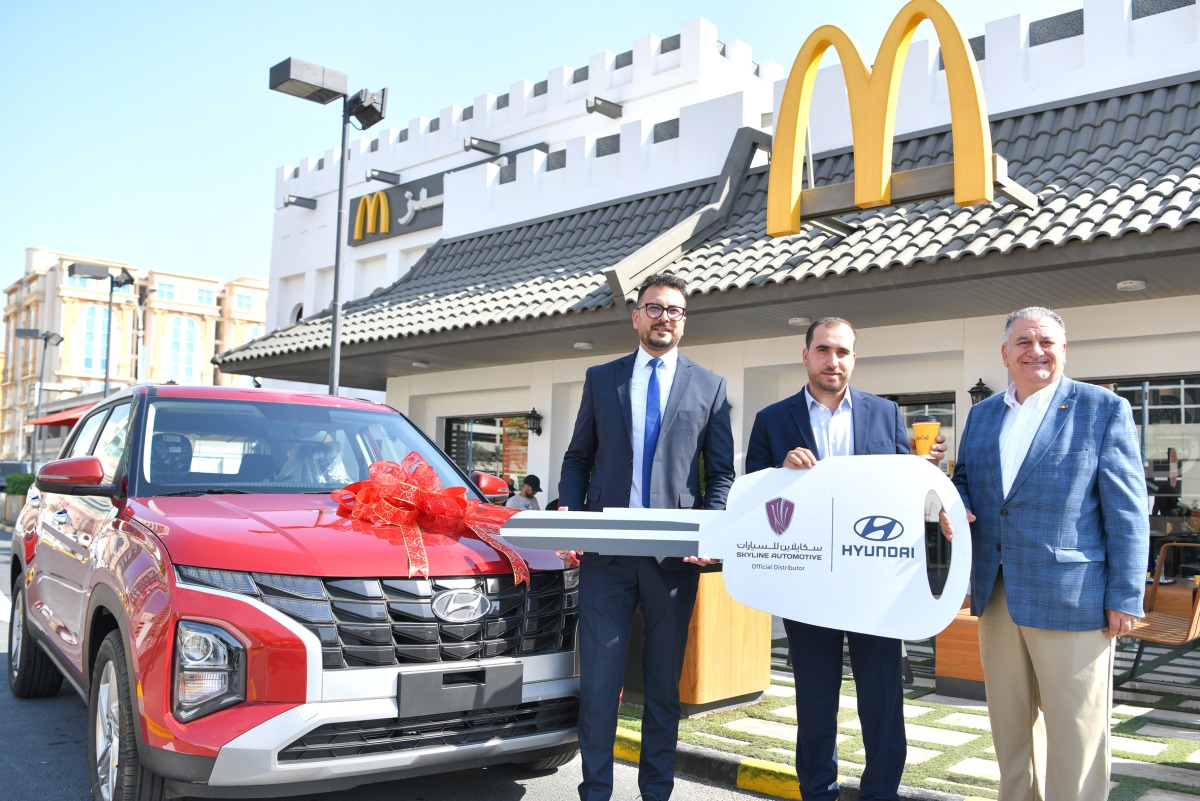 Officials of McDonald’s Qatar hand over the prize to a winner of the  ‘Scan & Win’ campaign.