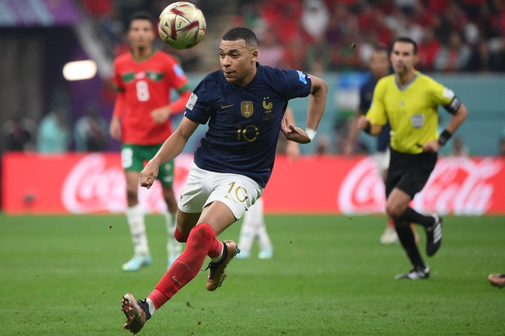 France's forward #10 Kylian Mbappe runs after the ball during the Qatar 2022 World Cup semi-final football match between France and Morocco at the Al-Bayt Stadium in Al Khor, north of Doha on December 14, 2022. (Photo by FRANCK FIFE / AFP)