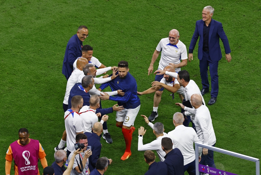 France's Olivier Giroud celebrates with coach Didier Deschamps and the coaching staff after the FIFA World Cup Qatar 2022 semi-final win against Morocco at the Al Bayt Stadium in Al Khor, Qatar, on December 14, 2022.  REUTERS/Peter Cziborra
 