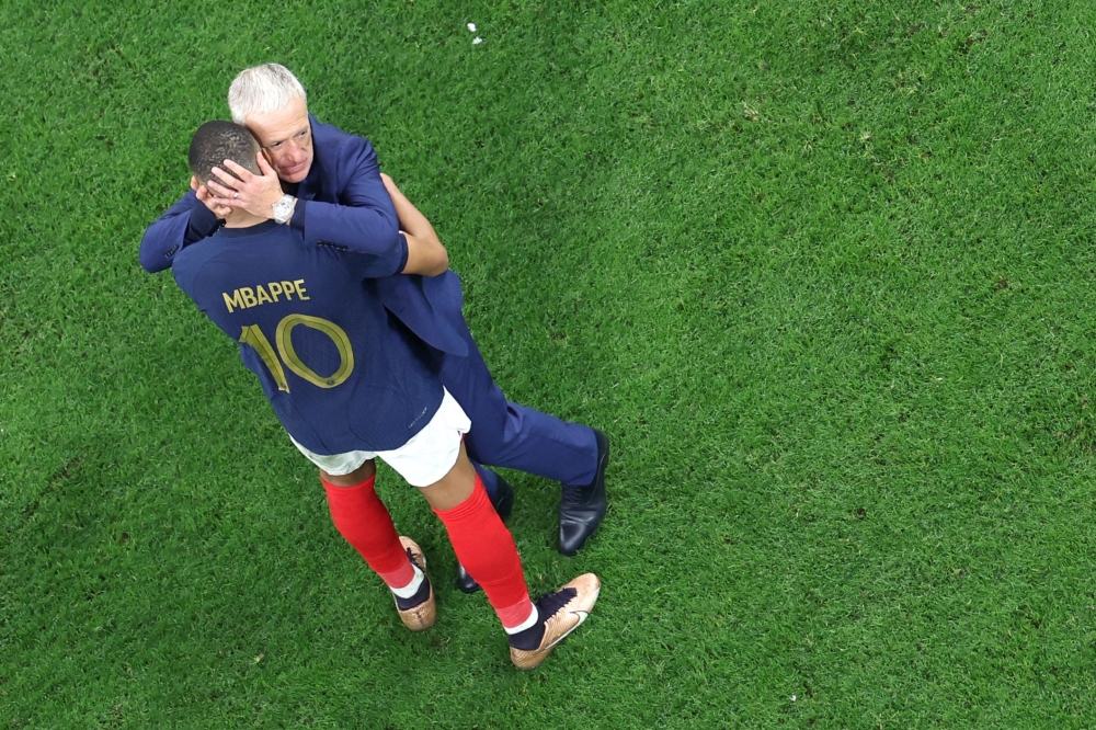 France's coach Didier Deschamps and France's forward #10 Kylian Mbappe after they won the Qatar 2022 World Cup semi-final football match between France and Morocco at the Al-Bayt Stadium on December 14, 2022. (Photo by Giuseppe Cacace / AFP)