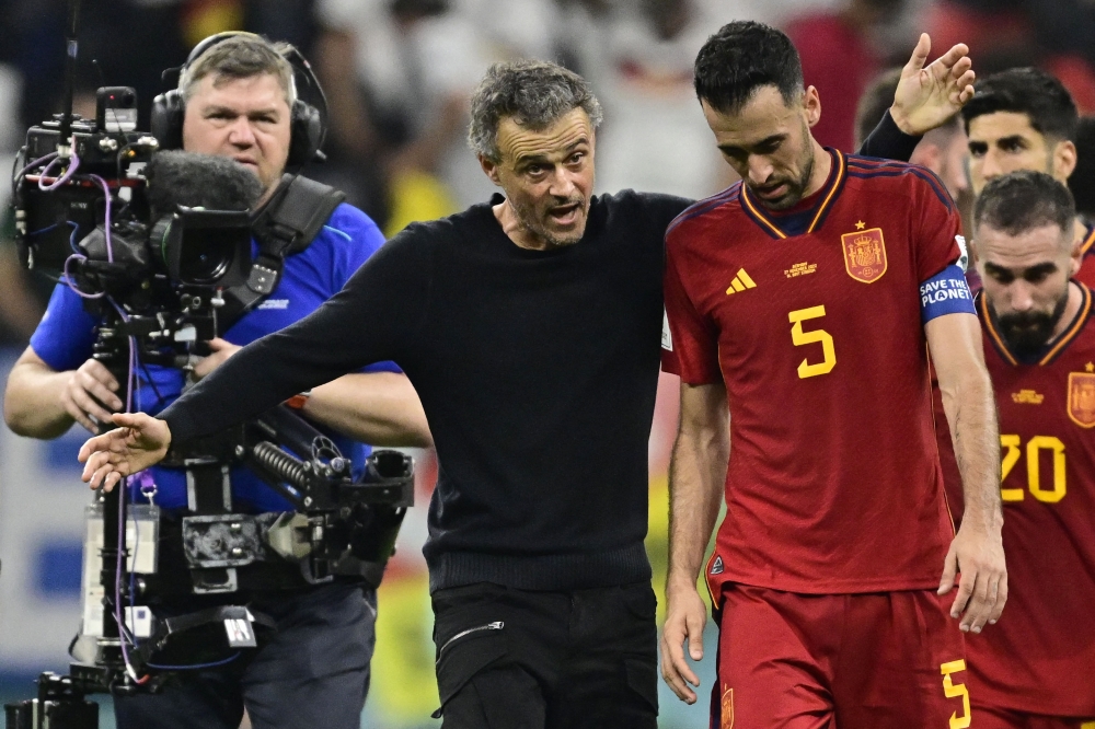 In this file photo taken on November 27, 2022 Spain's midfielder Sergio Busquets listens to Spain's coach Luis Enrique after the Qatar 2022 World Cup Group E football match between Spain and Germany at the Al-Bayt Stadium. (Photo by Javier Soriano / AFP)