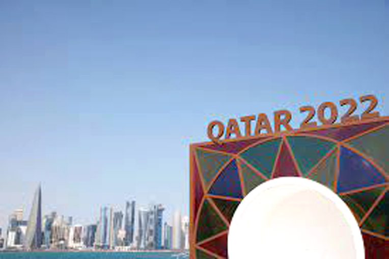 Qatar 2022 logo in front of the skyline of the West Bay in Doha.