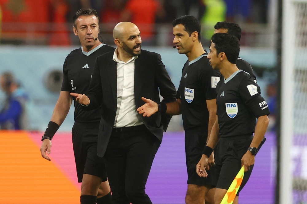 Morocco coach Walid Regragui talks to referee Abdulrahman Al Jassim after the FIFA World Cup Qatar 2022 third-place match against Croatia at the Khalifa International Stadium in Doha on December 17, 2022. REUTERS/Paul Childs