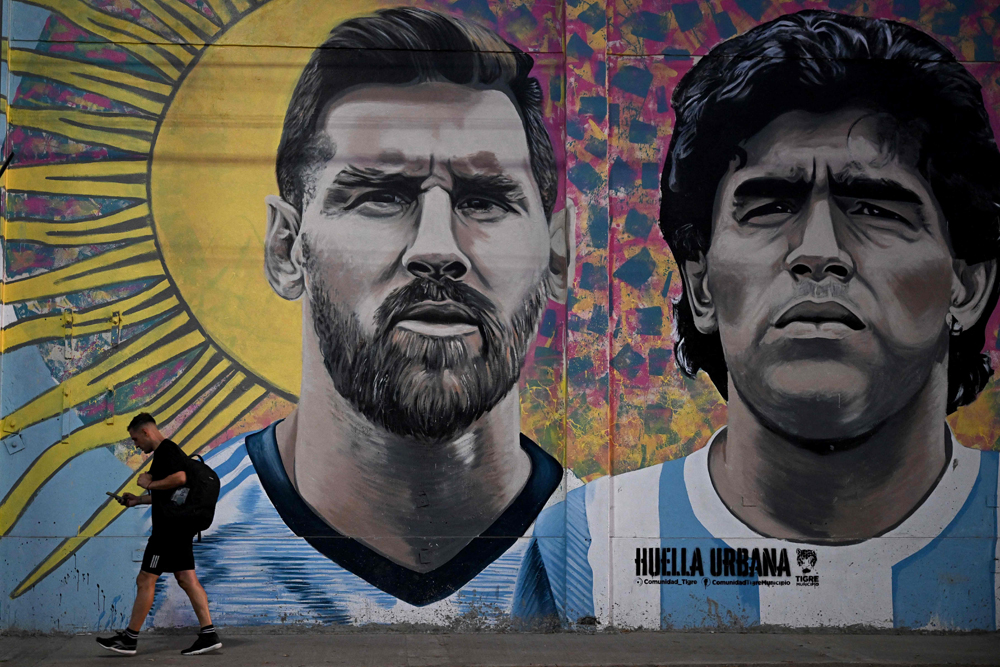 A mural depicting Argentine football stars Lionel Messi (left) and late Diego Maradona in Buenos Aires. AFP