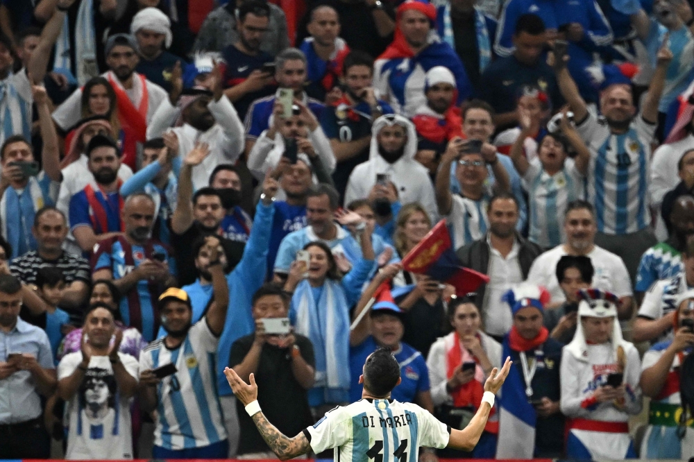 Argentina's midfielder Angel Di Maria celebrates scoring his team's second goal during the Qatar 2022 World Cup final football match between Argentina and France at Lusail Stadium in Lusail, north of Doha on December 18, 2022. (Photo by Anne-Christine POUJOULAT / AFP)