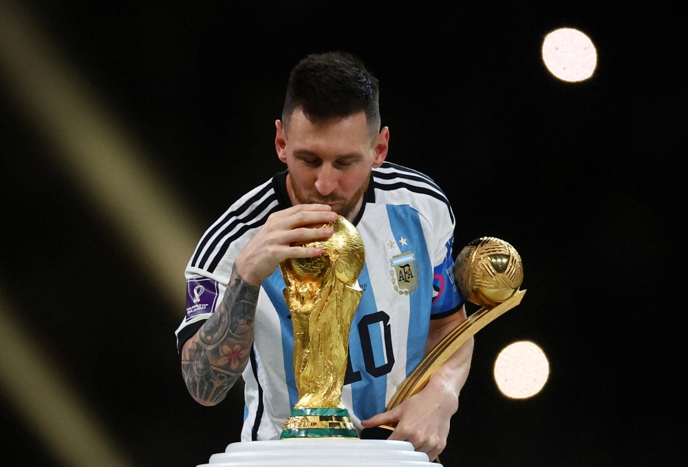 Argentina’s Lionel Messi kisses the World Cup trophy after receiving the Golden Ball award on Sunday. REUTERS