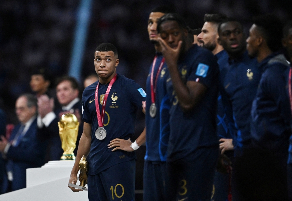 December 18, 2022 France's Kylian Mbappe reacts after receiving the runners up medal and the Golden Boot award REUTERS/Dylan Martinez