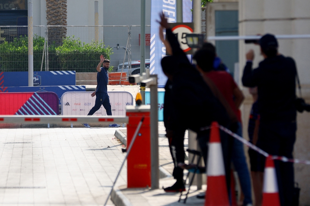 France's Olivier Giroud waves before departing from the team's FIFA World Cup Qatar 2022 hotel in Al Messila, Doha, Qatar on December 19, 2022.  REUTERS/Ibraheem Al Omari