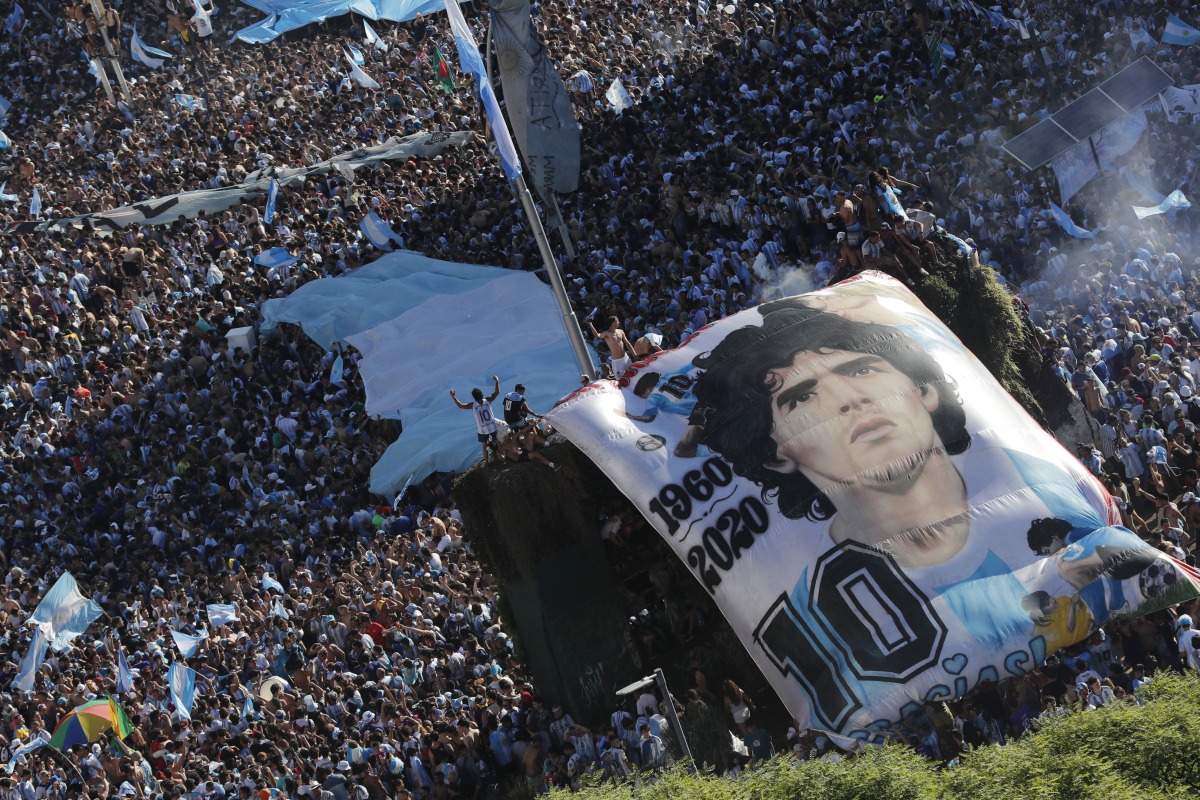 General view as Argentina fans with a Diego Maradona banner celebrate after winning the World Cup by the Obelisco in Buenos Aires. Reuters 