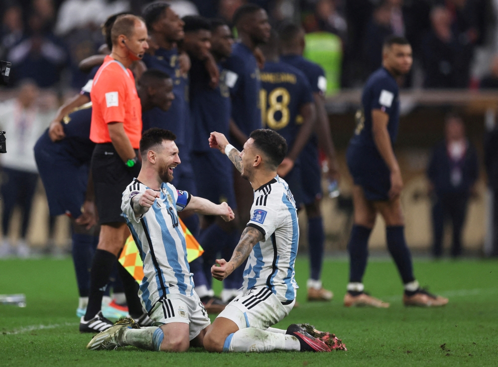 Argentina's Lionel Messi and Leandro Paredes celebrate after winning the FIFA World Cup Qatar final match against France at Lusail Stadium on December 18, 2022. (REUTERS/Lee Smith)