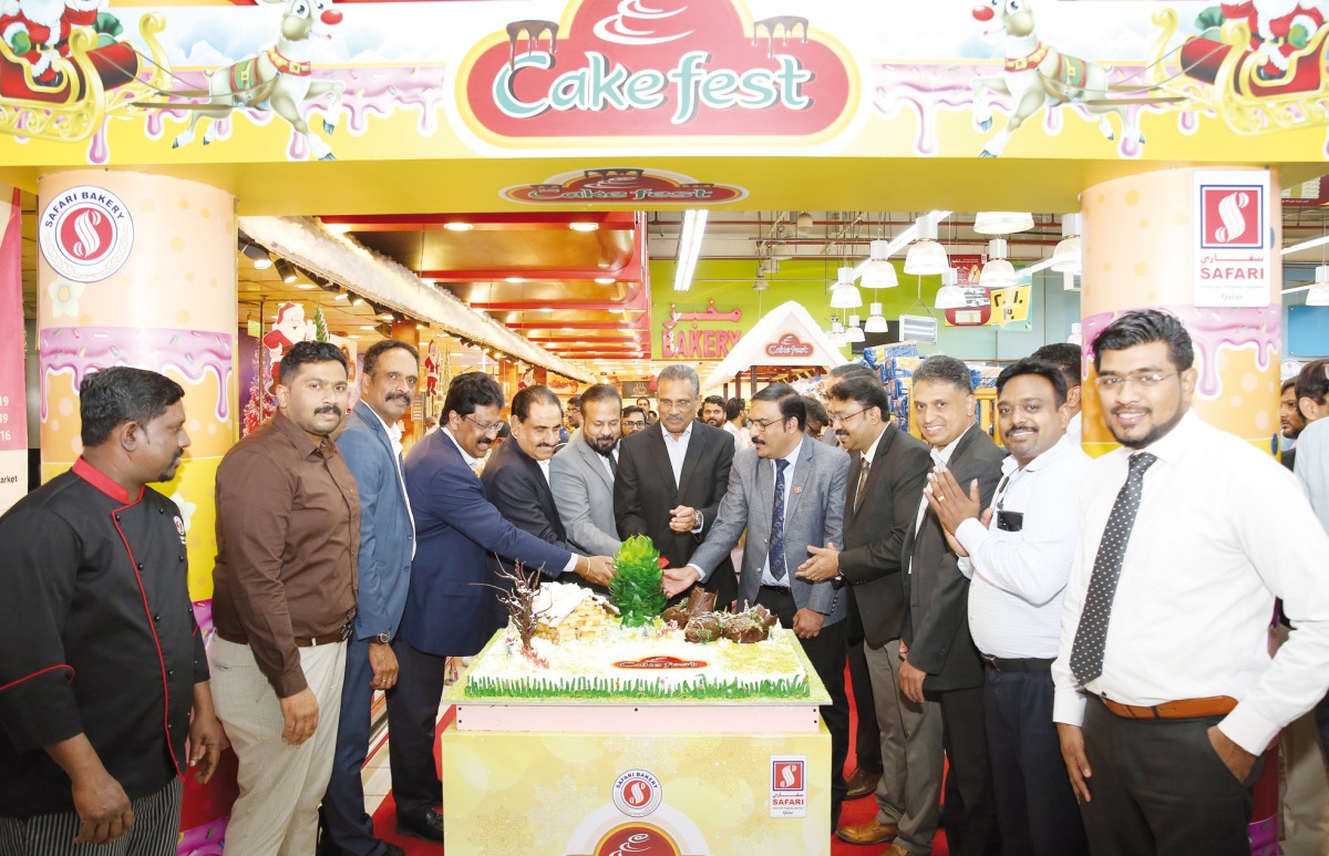 Safari Group Chairman Aboobakar Madappat, Director and Group General Manager Zainul Abideen and other officials cutting a cake to mark the launch of the promotion.