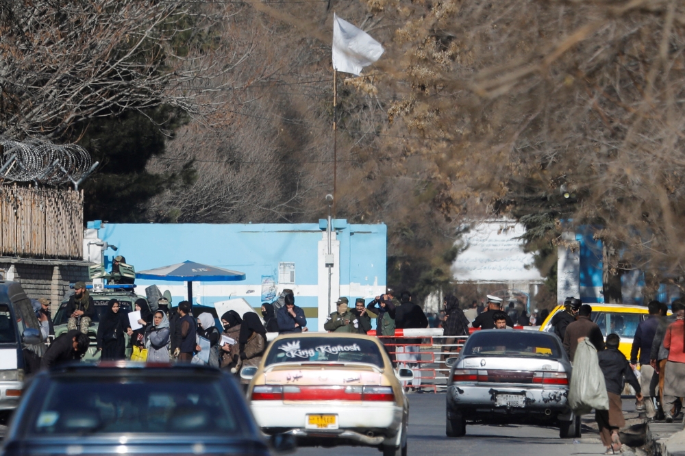 Members of the Taliban stand guard at the entrance gate of Kabul University in Kabul, Afghanistan, December 21, 2022. (REUTERS/Ali Khara)