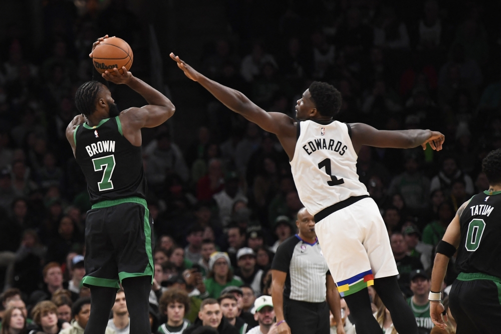 Boston Celtics guard Jaylen Brown (7) shoots the ball over Minnesota Timberwolves guard Anthony Edwards (1) during the second half at TD Garden. Bob DeChiara