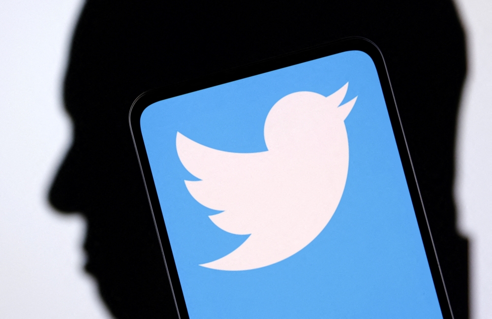 Twitter logo and Elon Musk silhouette are seen in this illustration taken on December 19, 2022. REUTERS/Dado Ruvic/Illustration/File Photo