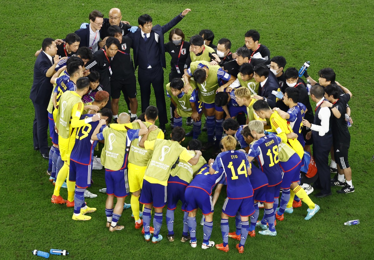 Japan coach Hajime Moriyasu, coaching staff and players in a huddle before the penalty shootout against Croatia, in this December 5 file photo. REUTERS