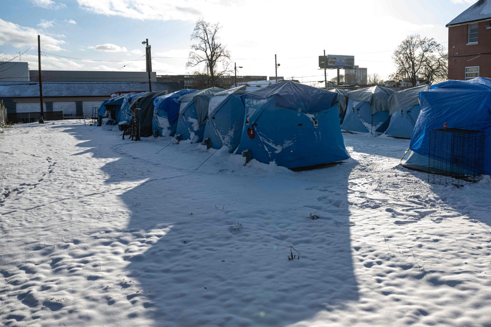 A row of tents is seen at The Hope Village, a secure tent encampment established for homeless people, on December 24, 2022 in Louisville, Kentucky. Heavy winter precipitation and temperatures 40 degrees below average are expected throughout the Christmas weekend over much of the United States. Jon Cherry/Getty Images/AFP