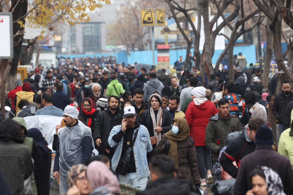 Iranians walk through Tehran Bazaar, in Tehran, on December 25, 2022. Majid Asgaripour/WANA (West Asia News Agency) via REUTERS