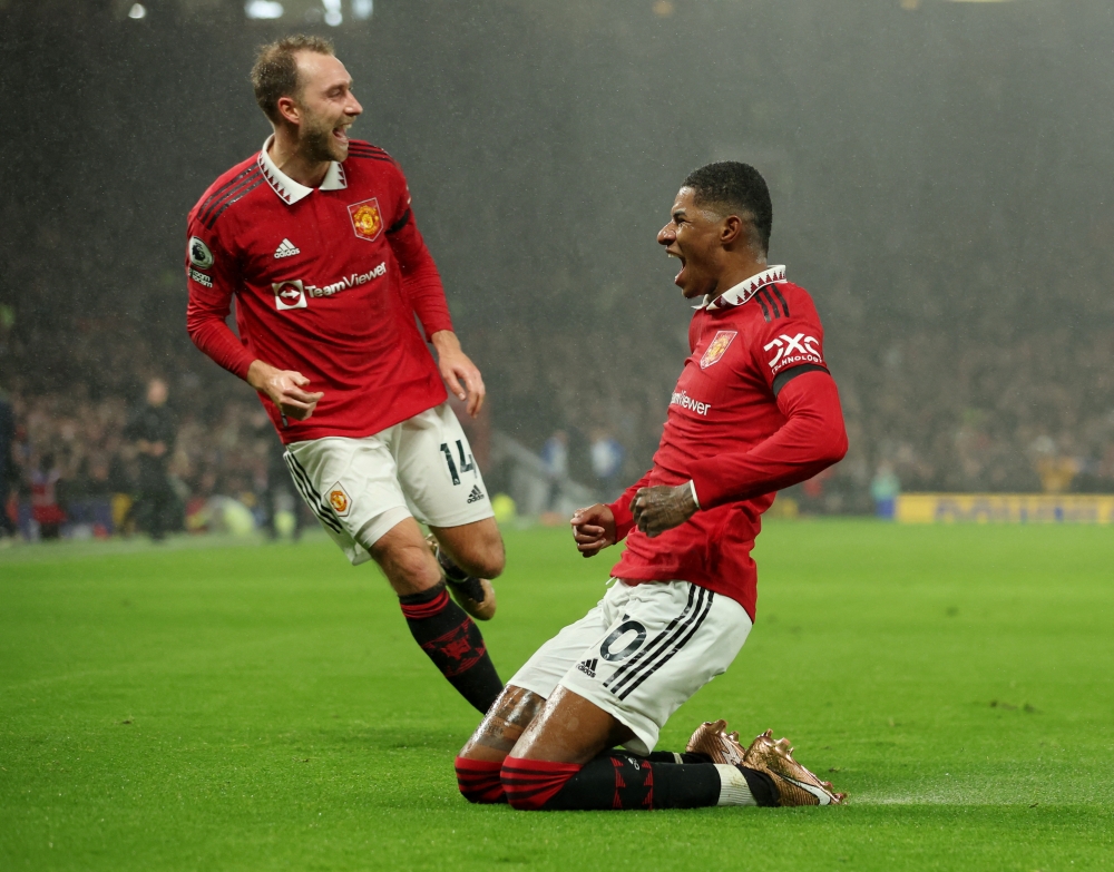 Manchester United's Marcus Rashford celebrates scoring their first goal with Christian Eriksen during the English Premier League match against Nottingham Forest at the Old Trafford, Manchester, Britain, on December 27, 2022.   REUTERS/Phil Noble