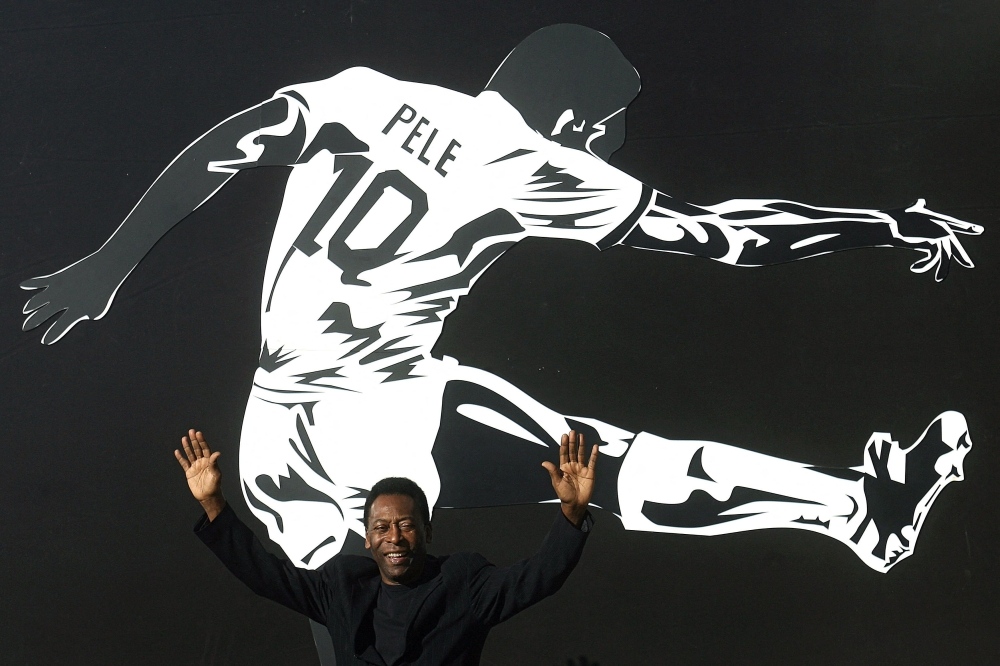 In this file photo taken on June 25, 2008 Brazilian soccer legend Edson Arantes do Nacimento, known as Pele, raises his arms during the opening ceremony of the 