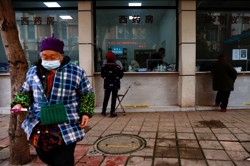 Elderly people pick up medicine at a pharmacy near a hospital after strict measures to curb the coronavirus disease (COVID-19) were removed nationwide, in Yongquan town of Jianyang, Sichuan province, China December 29, 2022. REUTERS/Tingshu Wang