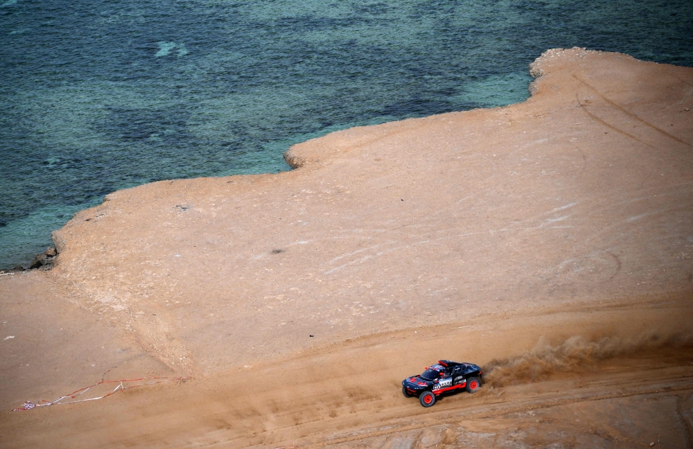 Swedish driver Mattias Ekstrom, with his co-driver Emil Bergkvist of Sweeden, steers his Audi's Hybrid during the prologue of the Dakar 2023 by the Red Sea in Yanbu, Saudi Arabia, on December 31, 2022. (Photo by FRANCK FIFE / AFP)