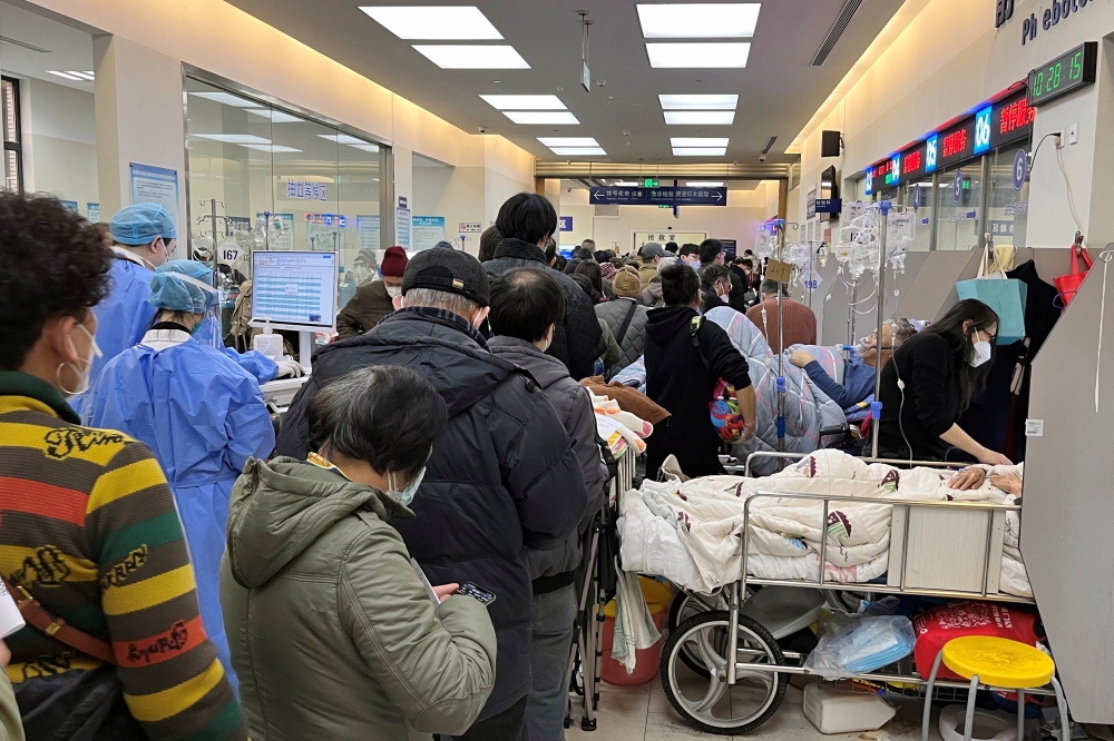 Patients lie on beds next to closed counters at the emergency department of Zhongshan Hospital, amid the coronavirus disease (COVID-19) outbreak in Shanghai, China January 3, 2023. REUTERS/Staff