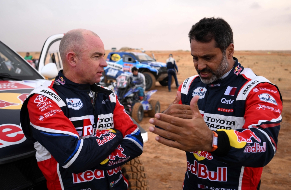 Nasser Al-Attiyah of Qatar (right), who tops the standings, with Giniel De Villiers after Tuesday's rain-affected Stage 3 of the Dakar 2023 between al-Ula and Hail in Saudi Arabia on January 3, 2023. (Photo by FRANCK FIFE / AFP)