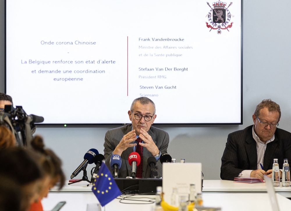 Chairman of the scientific committee on Covid-19, Steven Van Gucht (hidden), Vice-Prime Minister and Public Health and Social Affairs Minister Frank Vandenbroucke and the President of the Risk Management Group (RMG) Stefaan Van Der Borght attend a press conference after a meeting of the RMG concerning visitors from China and the risk of Covid-19 spreading, in Brussels, on January 2, 2023. (Photo by JAMES ARTHUR GEKIERE / Belga / AFP) 