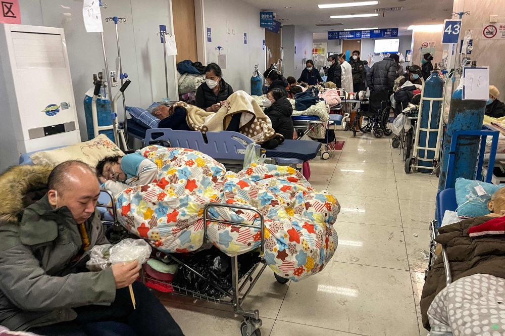 Patients on stretchers are seen at Tongren hospital in Shanghai on January 3, 2023. - A senior doctor at Shanghai's Ruijin Hospital has said 70 percent of the megacity's population may have been infected with Covid-19 during China's huge surge in cases, state media reported on January 3. (Photo by Hector RETAMAL / AFP)