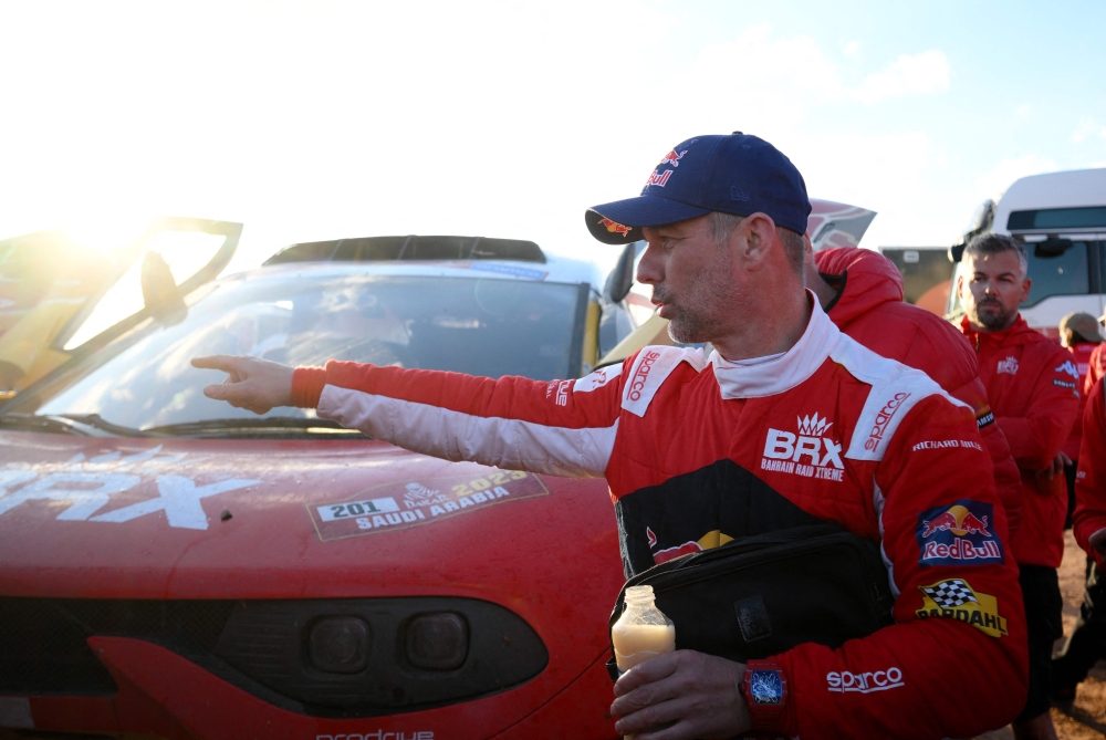 French driver Sebastien Loeb reacts after winning the fourth stage of the 2023 Dakar rally around Ha'il in Saudi Arabia on January 4, 2023. (Photo by FRANCK FIFE / AFP)