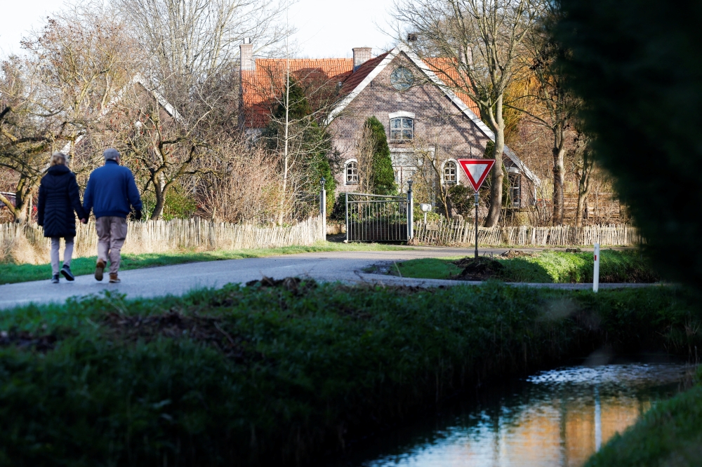 People walk on a street in the Dutch village Ommeren, Netherlands, January 6, 2023. (REUTERS/Piroschka van de Wouw)