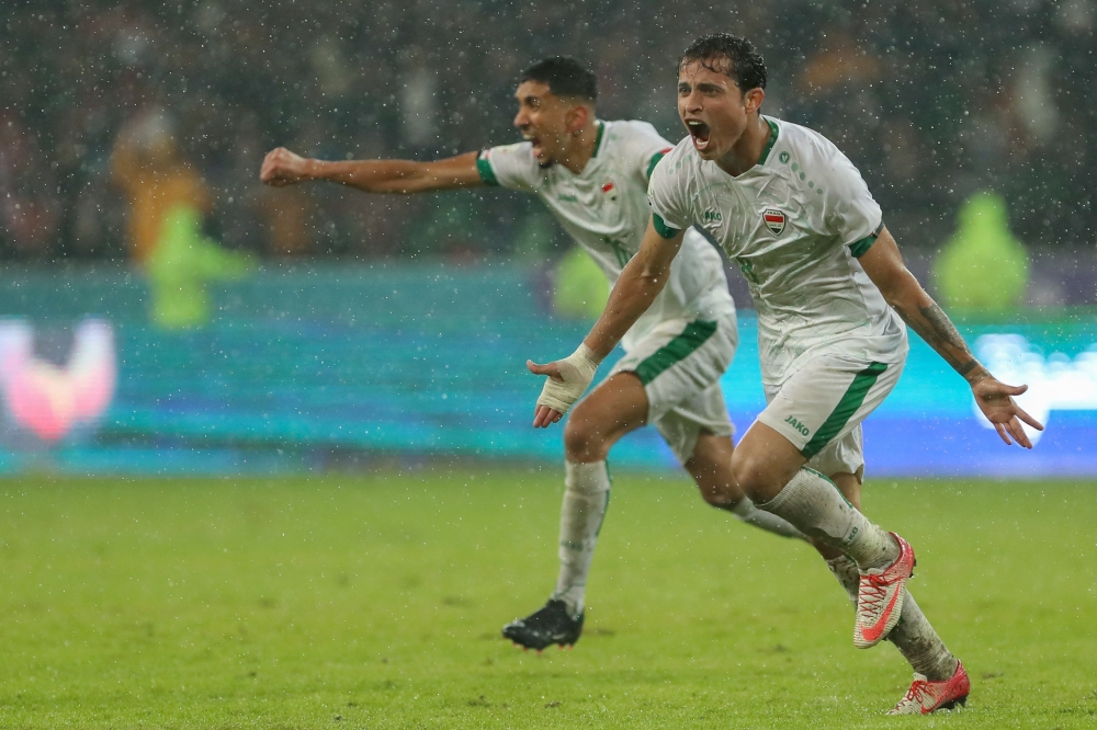 Iraq's midfielder Ibrahim Bayesh (right) celebrates scoring during the Arabian Gulf Cup football match between Iraq and Saudi Arabia at the Basra International Stadium in Iraq's eponymous southern city on January 9, 2023. (Photo by Hussein Faleh / AFP)