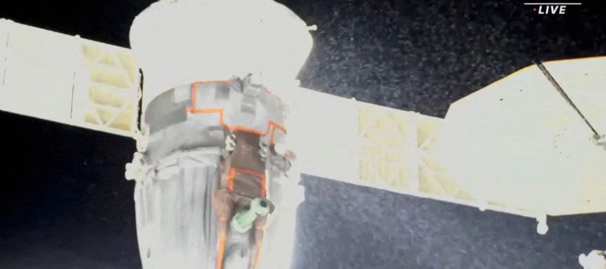 A stream of particles, which NASA says appears to be liquid and possibly coolant, sprays out of the Soyuz spacecraft on the International Space Station, forcing a delay of a routine planned spacewalk by two Russian cosmonauts December 14, 2022 in this still image taken from video. (NASA TV/Handout via REUTERS)