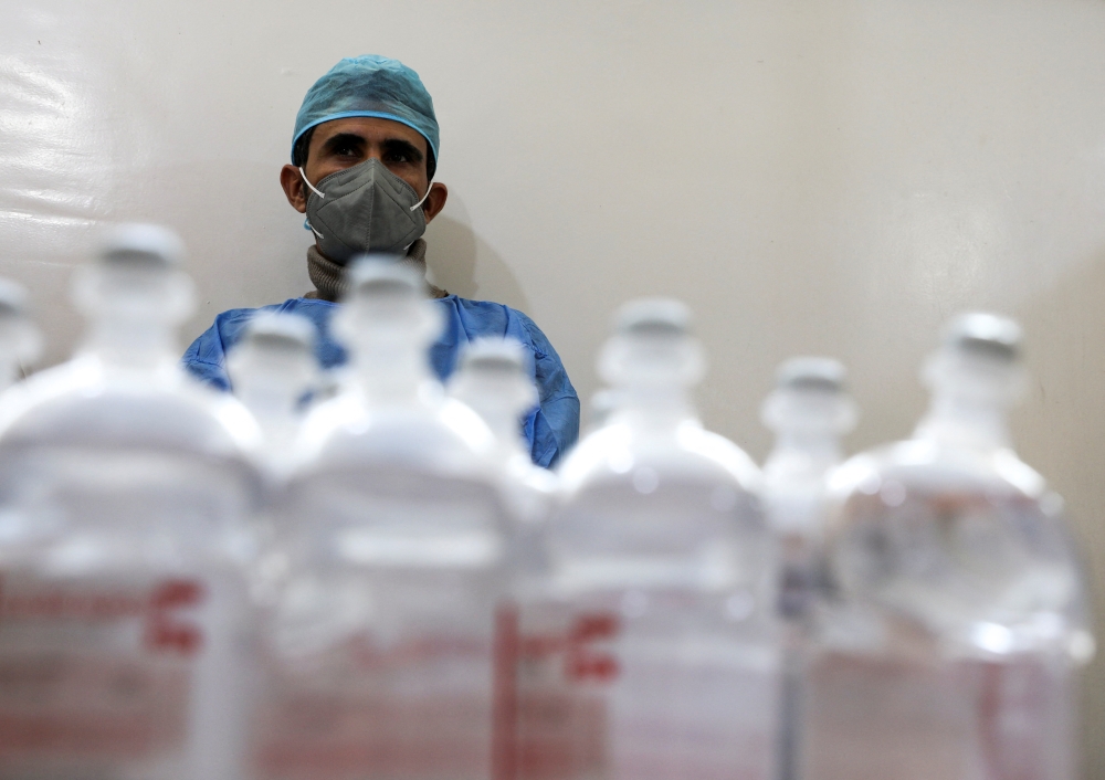 An employee of the National Oncology Center stands next to medicines at the center in Sanaa, Yemen, January 10, 2023. (REUTERS/Khaled Abdullah)