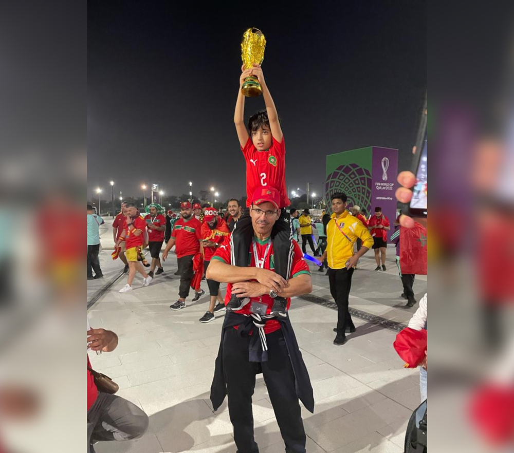 Mohammed Aderdor, one of the Moroccan community leaders in Qatar, with his son during one of the Moroccan games at the FIFA World Cup Qatar 2022.