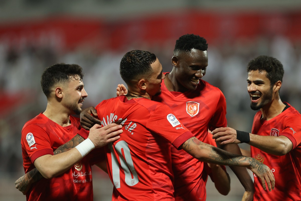 Michael Olunga celebrates with teammates after scoring a goal against Al Shamal.