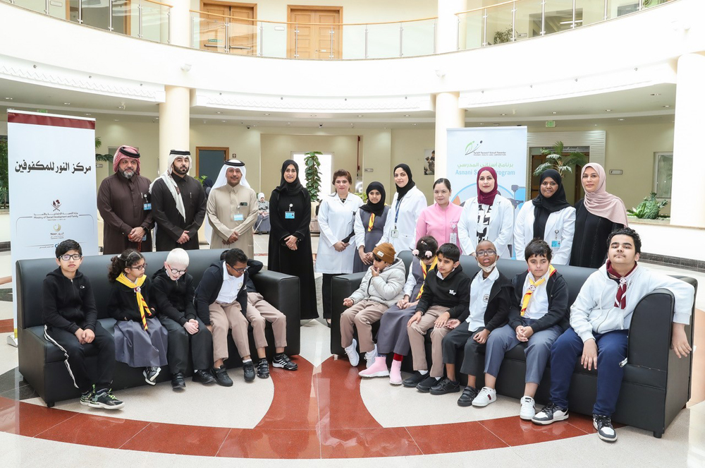 Officials with the students during an awareness and dental screening event. 