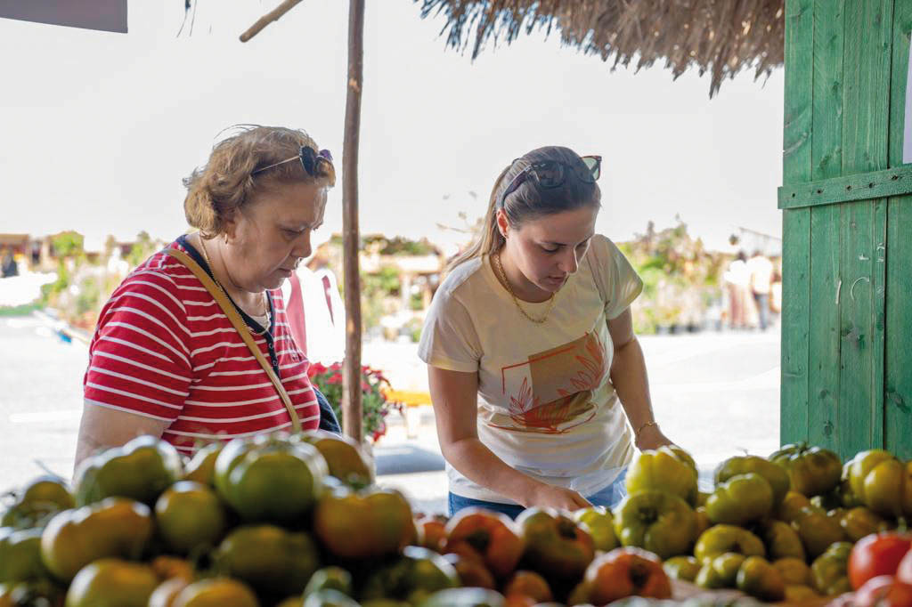 Visitors check on fruits and vegetables. 