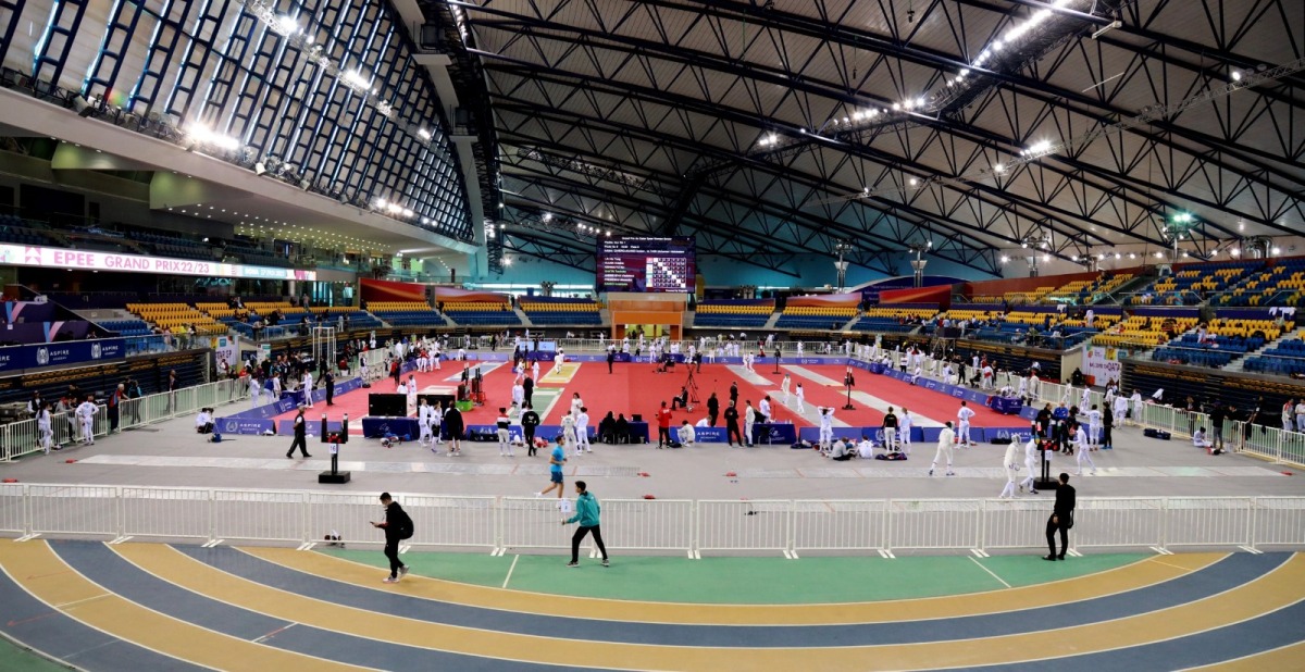 A general view inside the Aspire Dome during the Qatar Grand Prix Fencing Championship 2023. INSETS: Fencers in action 