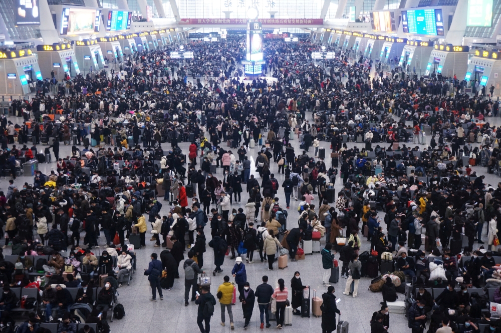 Travellers wait for their trains at Hangzhou East railway station during the Spring Festival travel rush ahead of the Chinese Lunar New Year, in Hangzhou, Zhejiang province, China January 20, 2023. China Daily via Reuters