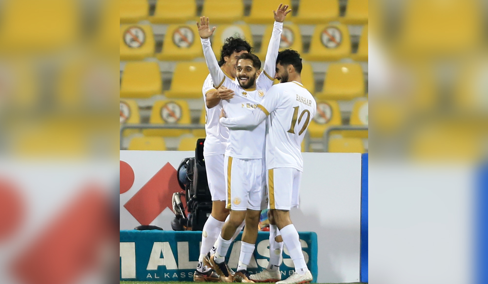 Qatar SC's Nasir Peer Baksh celebrates with teammates after scoring their second goal against Al Arabi, yesterday.