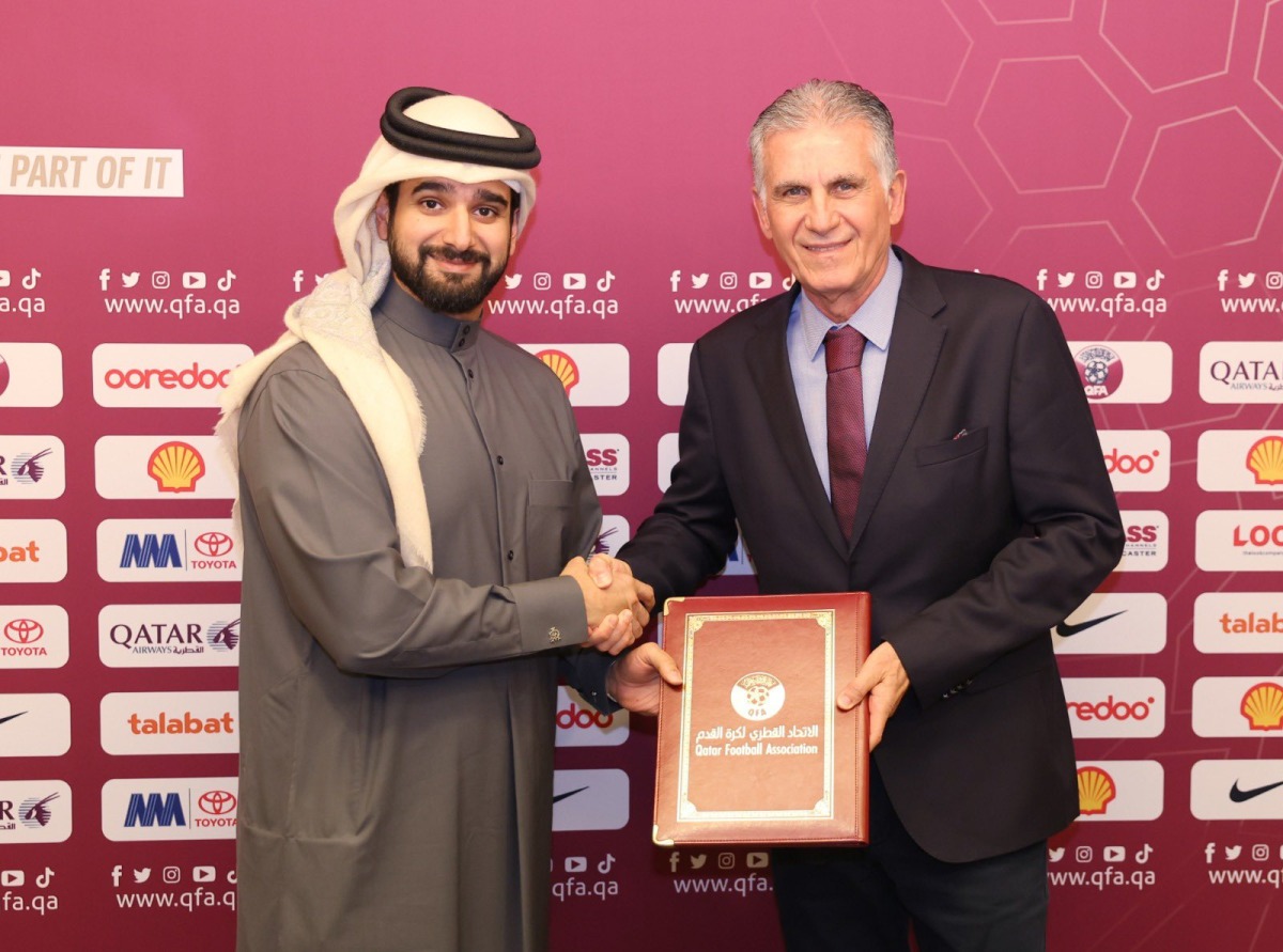 Qatar Football Association General Secretary Mansour Al Ansari and Carlos Queiroz shake hands after signing the contract yesterday.