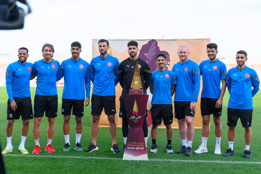 Al Duhail players pose with the Qatar Cup trophy.