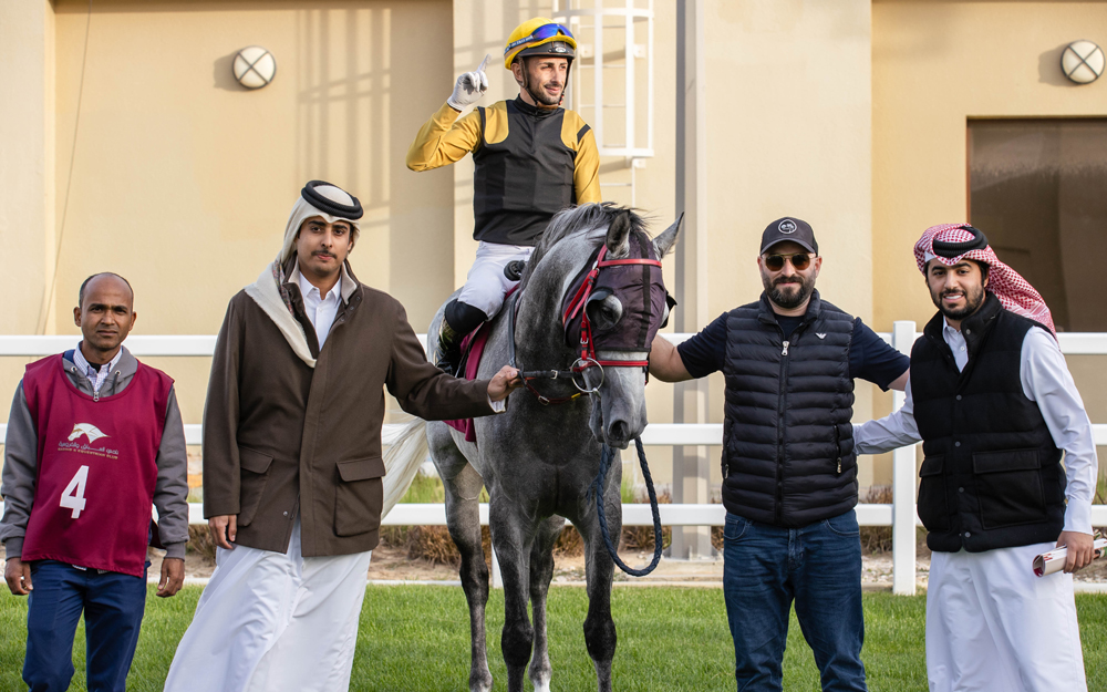 The connection of Ghannam celebrate after the Abdullah Saeed Abdullah Al Mesnad-owned seven-year-old horse won the Al Arish Cup at Al Uqda Racecourse yesterday. PICS: JUHAIM/QREC