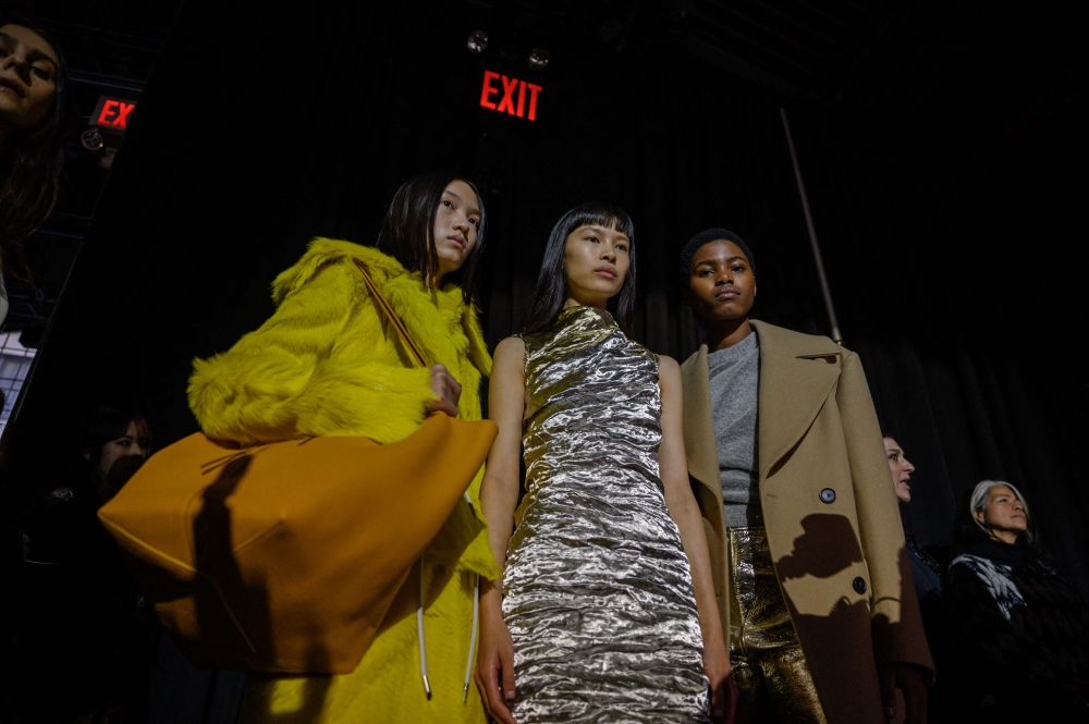 Models wearing creations by Proenza Schouler gather backstage prior to their runway show during New York Fashion Week on February 11, 2023. (Photo by Ed JONES / AFP)