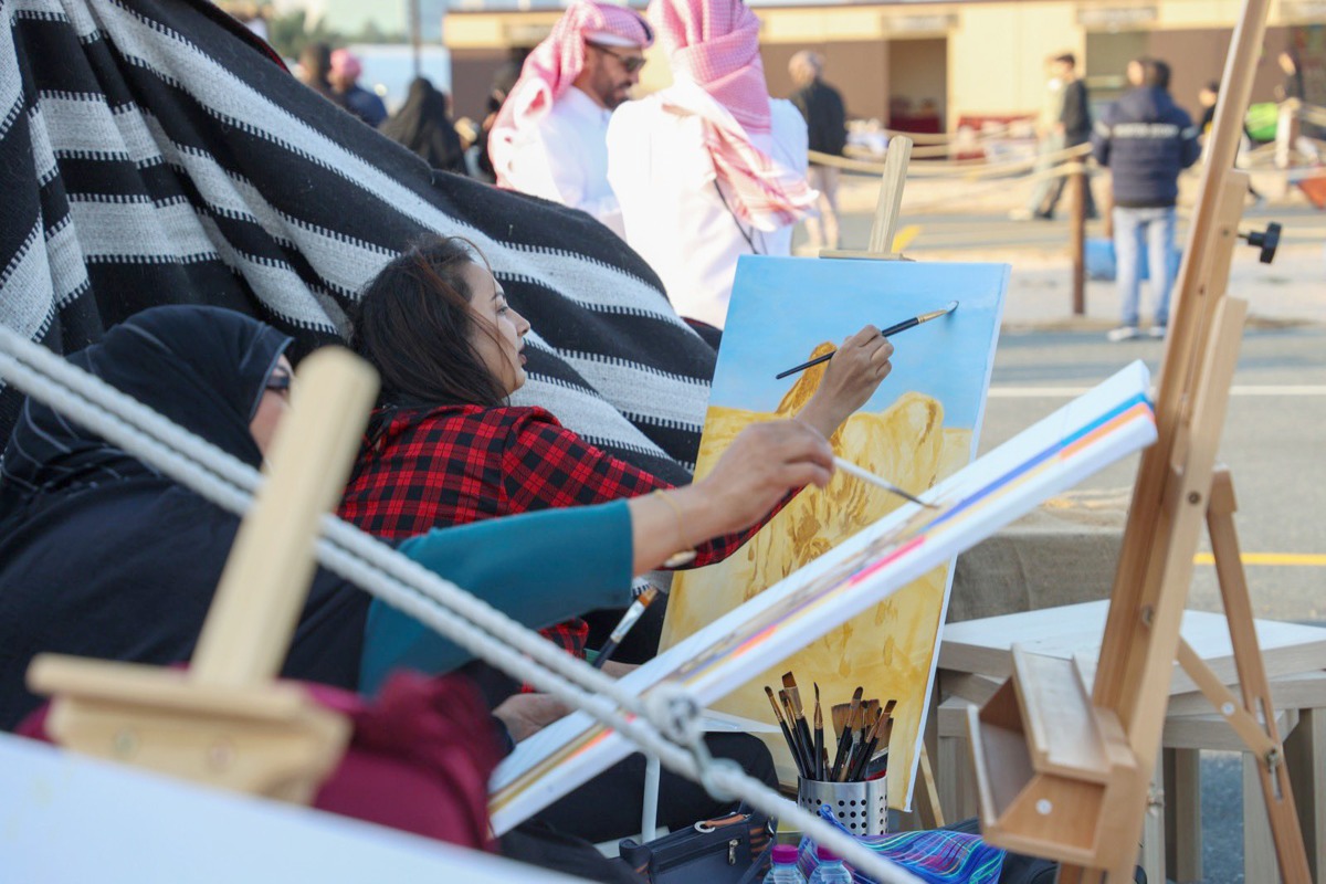 Artists work on their paintings, as part of Halal Qatar Festival being held at Katara Cultural Village. 