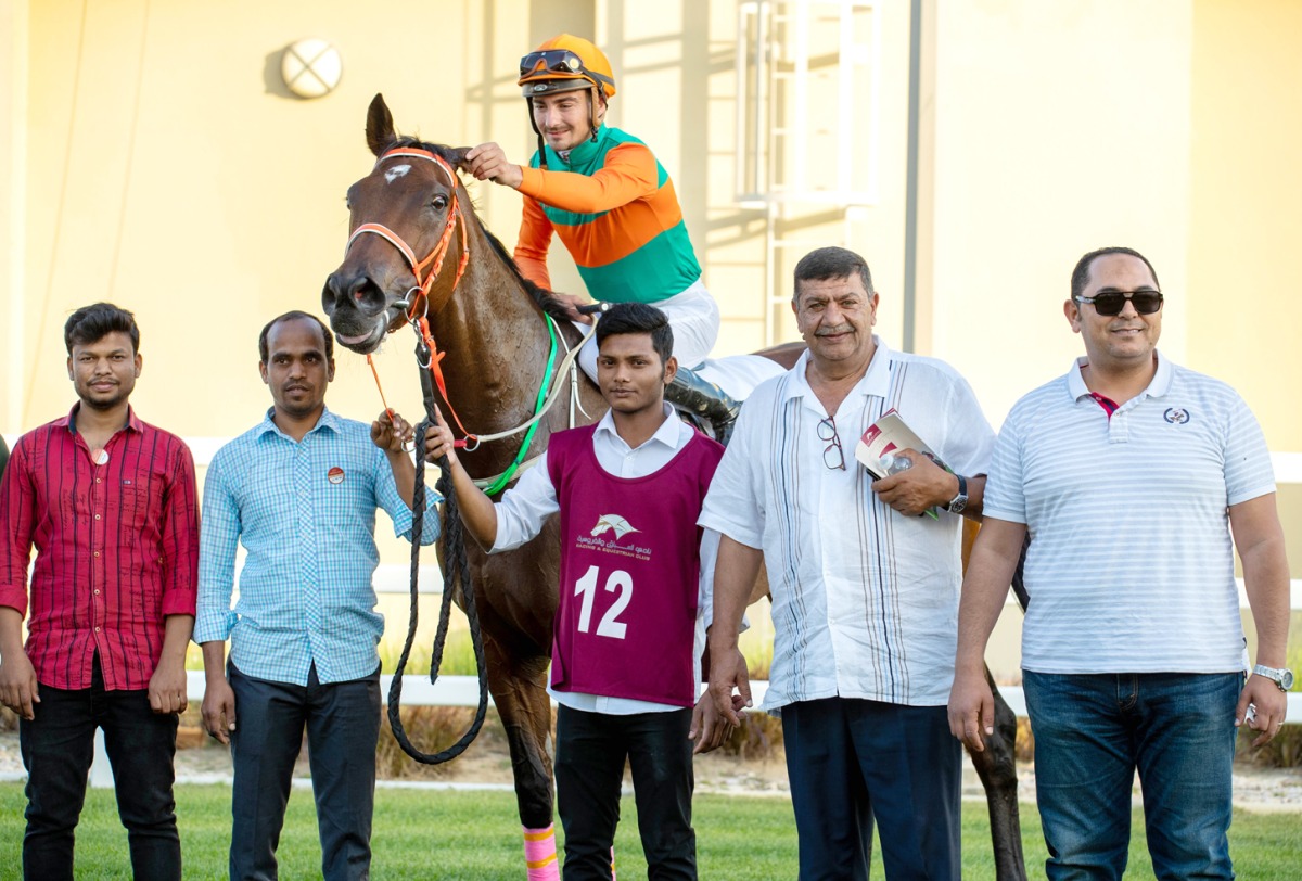 The connection of Al Shomos celebrate after the Mubarak bin Saeed Aljafai Al Naimi-owned mare won the Local Thoroughbred Trophy at Al Uqda Racecourse yesterday.  Pictures: Juhaim/QREC
