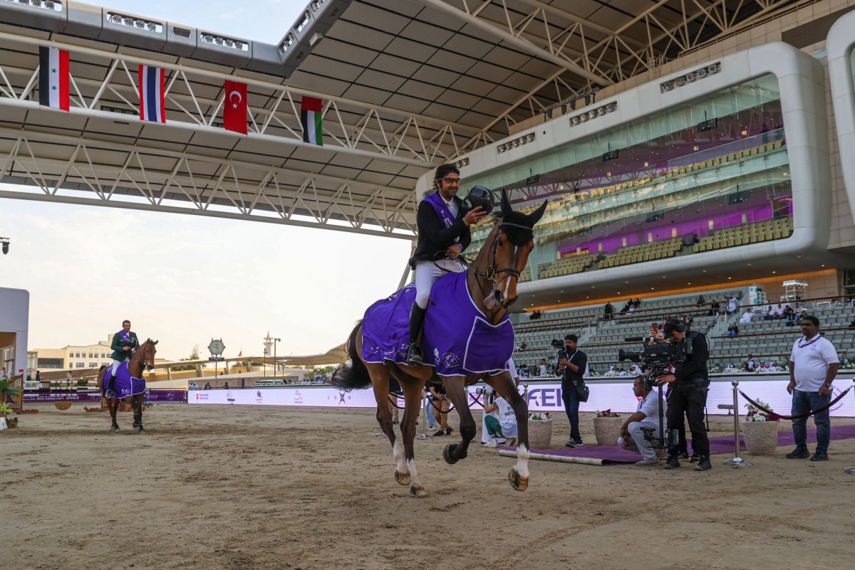 Egypt’s Karim Elzoghby astride Zandigo celebrates after finishing the jump off.   