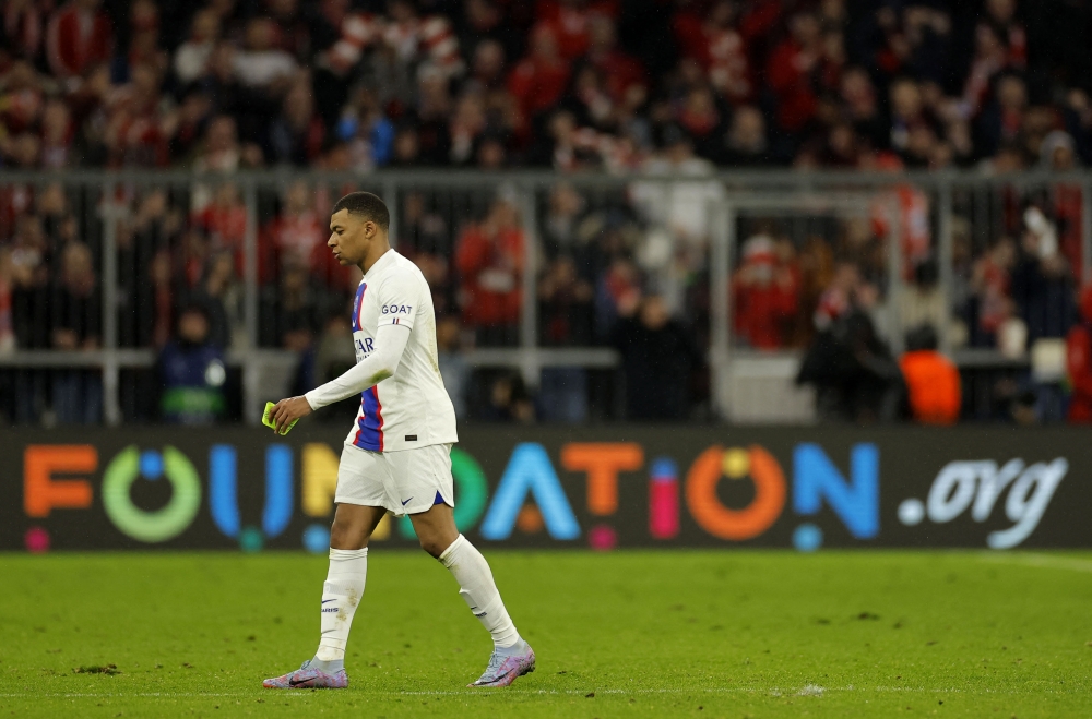 Paris Saint-Germain's French forward Kylian Mbappe walks over the pitch after the UEFA Champions League round of 16. (Photo by Odd ANDERSEN / AFP)