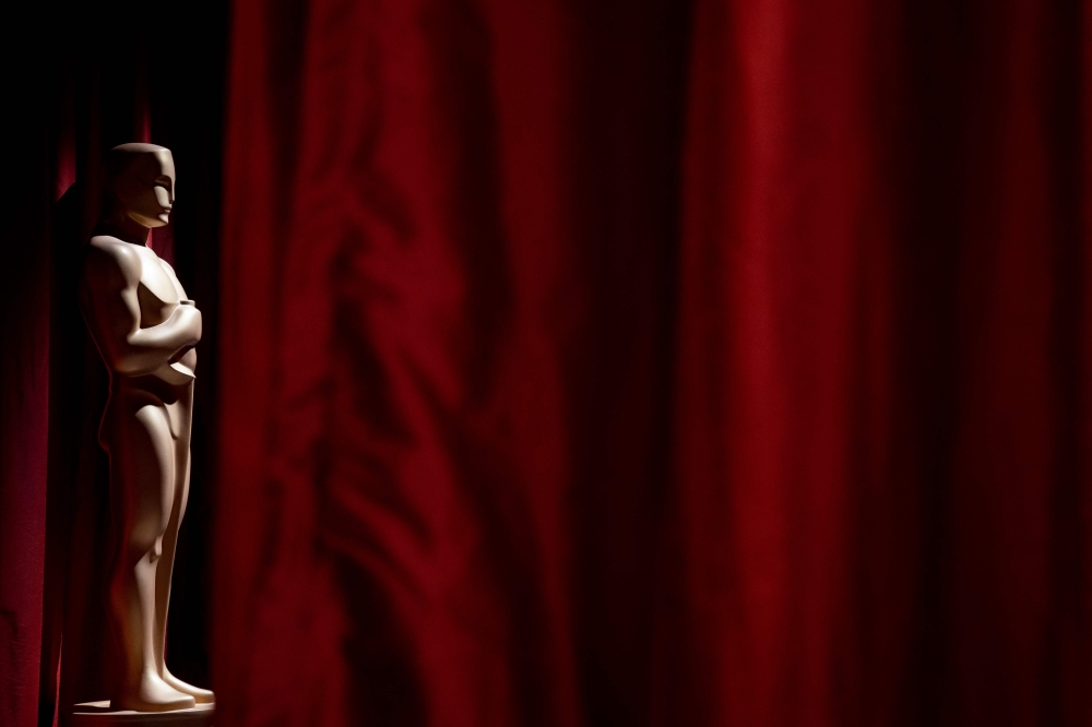 A decorative Oscar statue stands near red drapes as final preparations are made for the 95th Academy Awards, in Hollywood, Los Angeles, California, on March 11, 2023. (Photo by Stefani Reynolds / AFP)